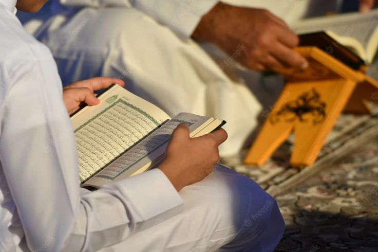Person reflecting on Quran